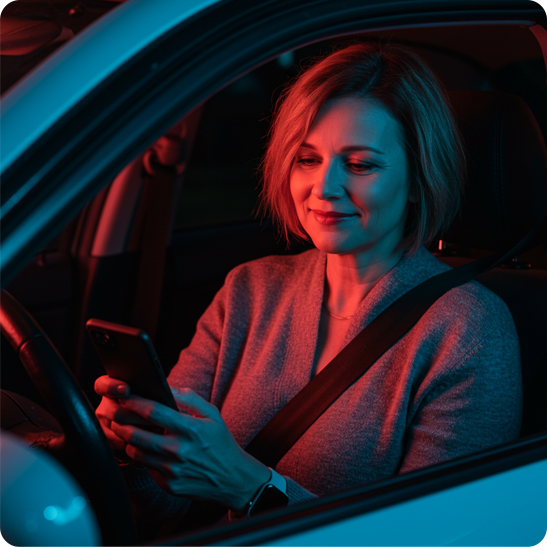 Woman searching on her smartphone while sitting in her car