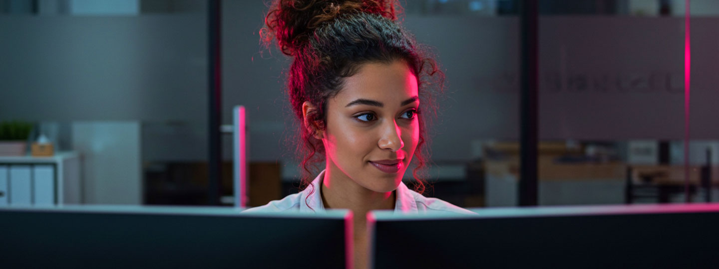 Girl working on two moniters