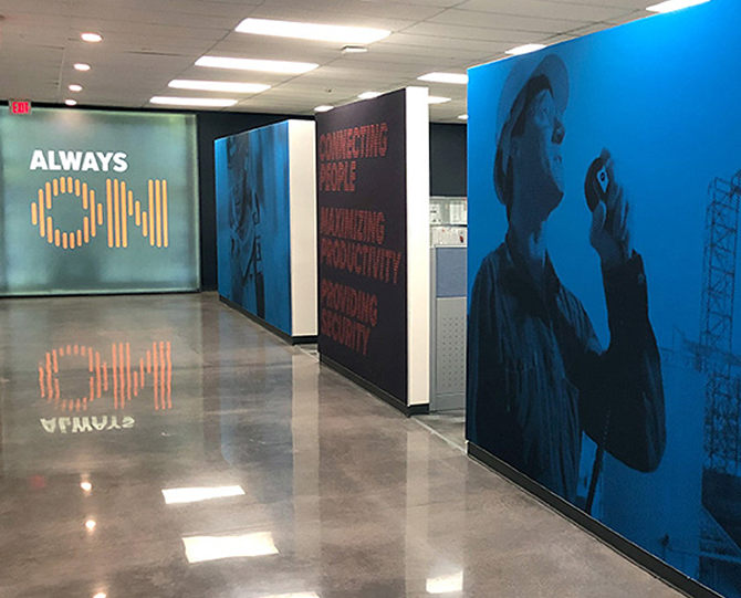 BearCom office hallway with large branded wall graphics, including an Always On display