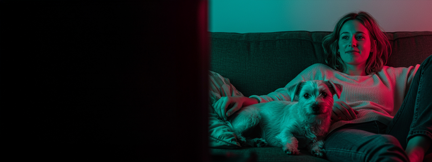 girl watching tv with dog