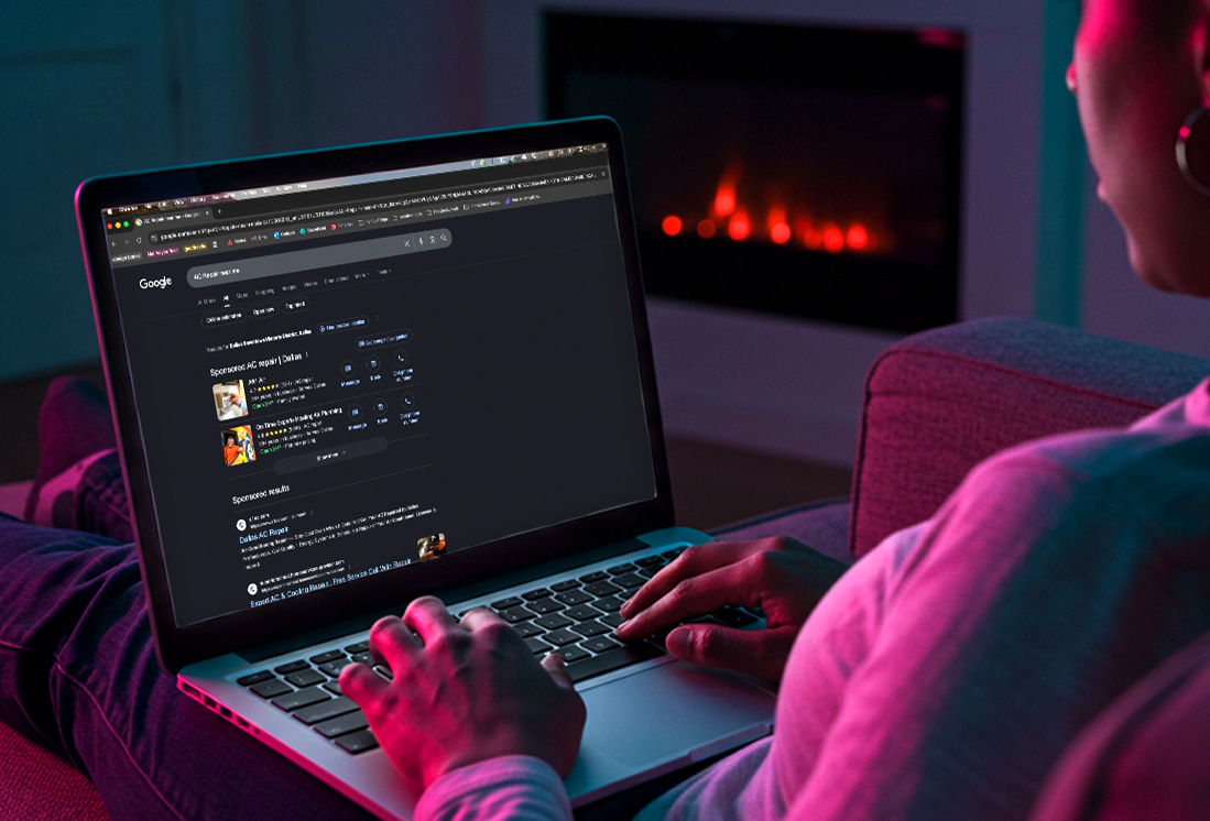 Person browsing Google search results on a laptop at home