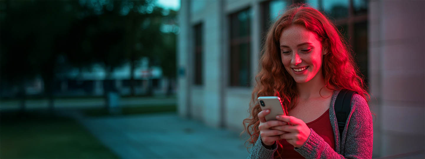Girl using phone and smiling