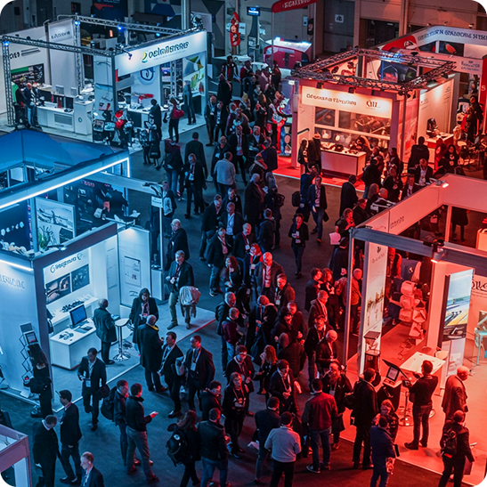 Aerial view of a busy trade show floor with exhibitor booths