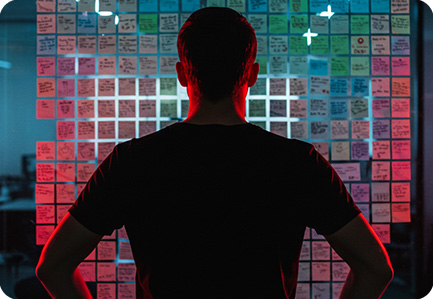 Men standing in front of AI screen